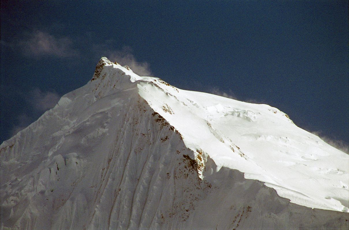 15 Chogolisa I And Long Ridge To Chogolisa II Close Up Late Afternoon From Shagring Camp On Upper Baltoro Glacier Chogolisa I (7665m) is on the left and Chogolisa II (7654m) is on the right, seen from Shagring camp on the Upper Baltoro Glacier. On August 4, 1958 a Japanese expedition organized by the Academic Alpine Club of Kyoto led by Takeo Kawabara made the first ascent of Chogolisa II, with Masao Fujihira and Kazumasa Hirai reaching the summit. The first ascent of Chogolisa I (7665m) was made on August 2, 1975 by Fred Pressl and Gustav Ammerer of an Austrian expedition led by Eduard Koblmuller. Koblmuller almost suffered the same fate as Hermann Buhl, as he also fell through a cornice on the ascent; fortunately, he was roped and team members were able to pull him to safety.